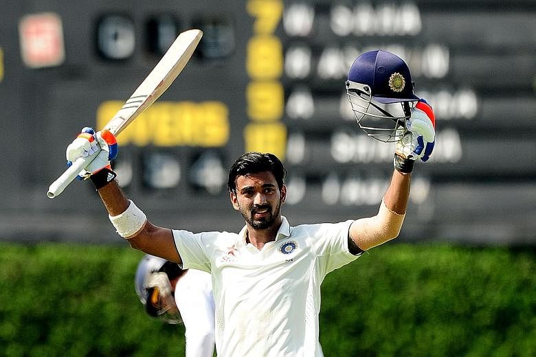 India opener Lokesh Rahul raises his bat and helmet in celebration after scoring a century on the opening day of the second Test match against Sri Lanka. His innings of 108 is the second Test century of his career.