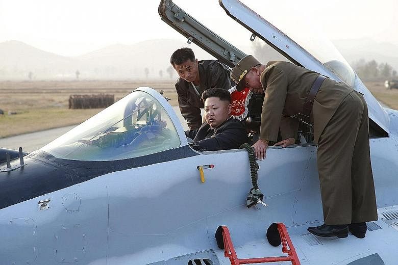 North Korean leader Kim Jong Un sitting in the cockpit of a plane (top), taking flight at a machine plant (above) and on board his plush jet.