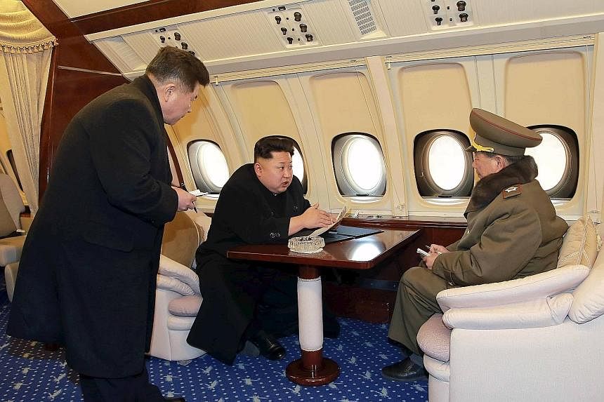 North Korean leader Kim Jong Un sitting in the cockpit of a plane (top), taking flight at a machine plant (above) and on board his plush jet.
