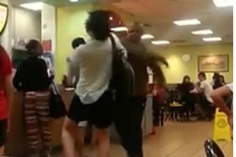 The video starts with one man in a white T-shirt and carrying a black backpack shouting at another man in a brown shirt. It leads to both men exchanging blows before a customer steps in to separate them.