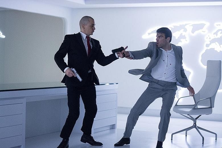 Agent 47 (Rupert Friend, far left) squares off against assassin John Smith (Zachary Quinto) in Hitman: Agent 47.