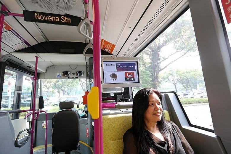 Officer manager Phyllis Chng, 62, gave her feedback on the passenger information display (above her) on trial in buses.