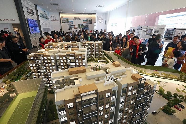 Potential buyers at The Brownstone EC's sales gallery in Sembawang last month. National Development Minister Khaw Boon Wan said in March that he was considering raising the income ceiling for ECs. Property circles have been abuzz that an announcement