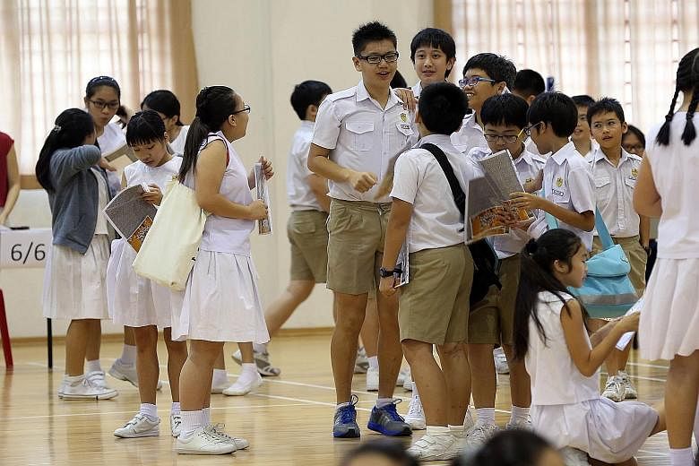 With the PSLE makeover, instead of getting a score out of 300 points, pupils will get grade bands. (Right) Kong Hwa pupils mingling on the day they received their PSLE results last year.