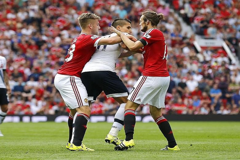Manchester United giving Tottenham winger Erik Lamela (centre) a taste of their double team of Daley Blind (right) and Luke Shaw. Such cohesiveness at the back saw United chalk up two straight league clean sheets.