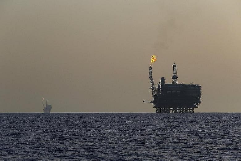 Offshore oil platforms at the Bouri Oil Field off the coast of Libya. The price of a barrel of oil has halved since June last year, reaching levels previously seen at the depths of the global financial crisis in 2009.