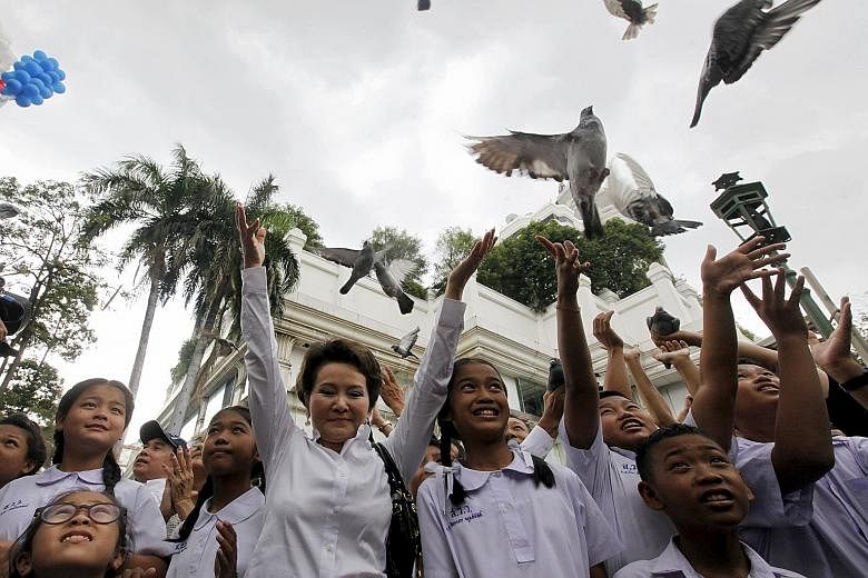 A group of Thai people releasing pigeons at the Erawan Shrine in central Bangkok yesterday, to mourn the victims of Monday night's deadly bomb attack at the site. Twenty people were killed and more than 120 were wounded in the incident.