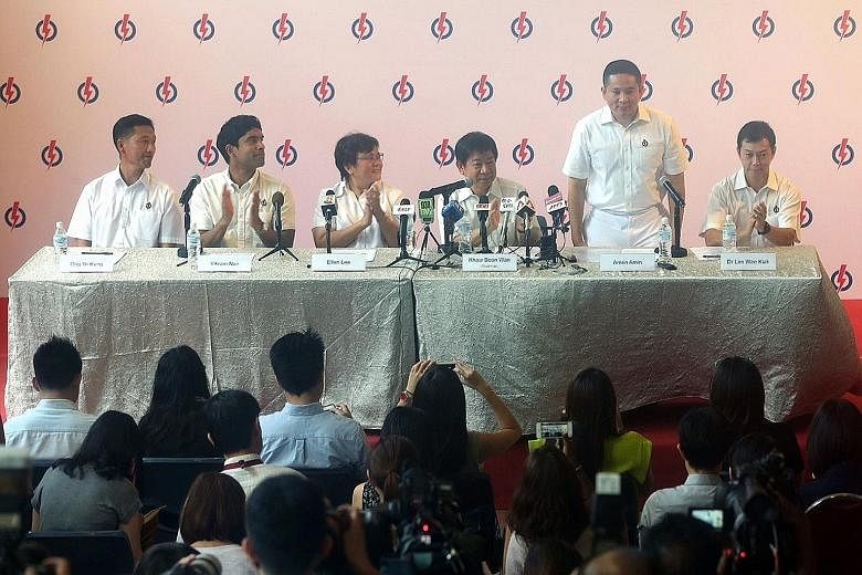 A new theme is emerging with new candidates. PAP newcomer Amrin Amin (standing) at a media conference.