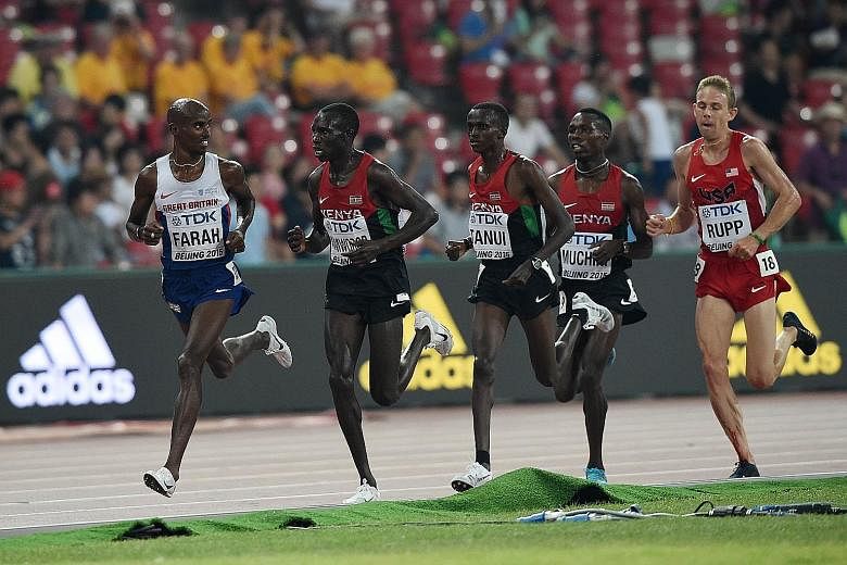 Britain's Mo Farah (left) on his way to an emphatic victory in the 10,000m at the IAAF World Championships at Beijing's Bird's Nest stadium last night.