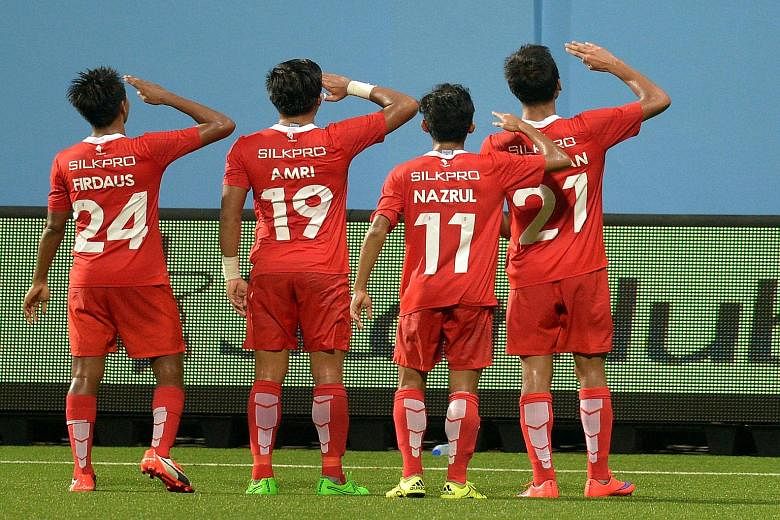 LionsXII players saluting fans after Khairul Amri converted for the side's second goal in the 3-0 MSL victory against Sime Darby at the Jalan Besar Stadium last night.