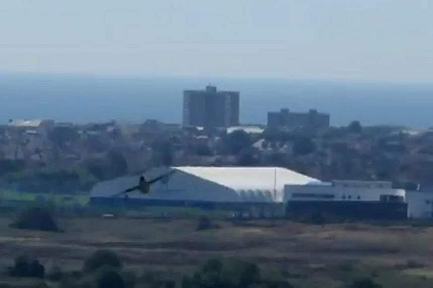 YouTube images show the plane at the Shoreham Air Show before it crashed and the fiery aftermath. Reports say the pilot was pulled from the burning wreckage.