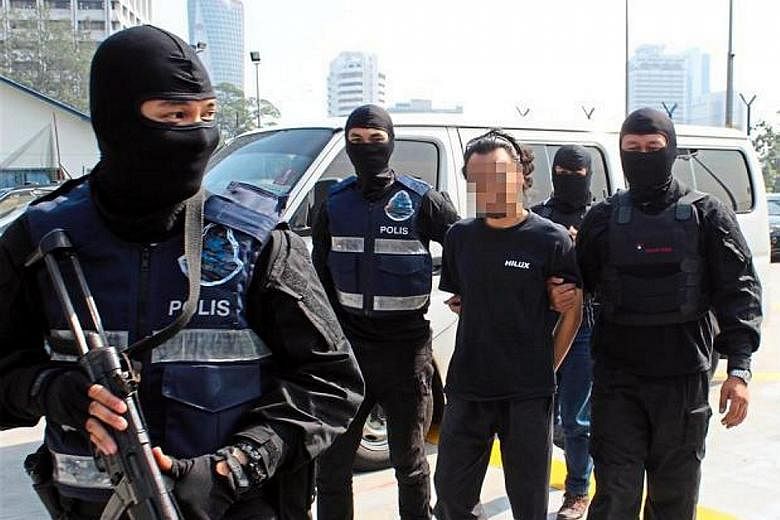 A man believed to be a member of ISIS being detained by Malaysian police for planned attacks in the Klang Valley. So far, 121 Malaysians have been arrested for suspected links with ISIS.