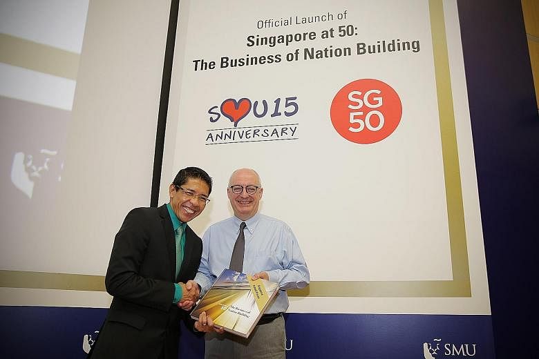 Professor Arnoud De Meyer (right), SMU president, presenting a copy of the book to Dr Mohamad Maliki Osman, Minister of State for National Development and Defence, and Mayor, South East District, last Friday.