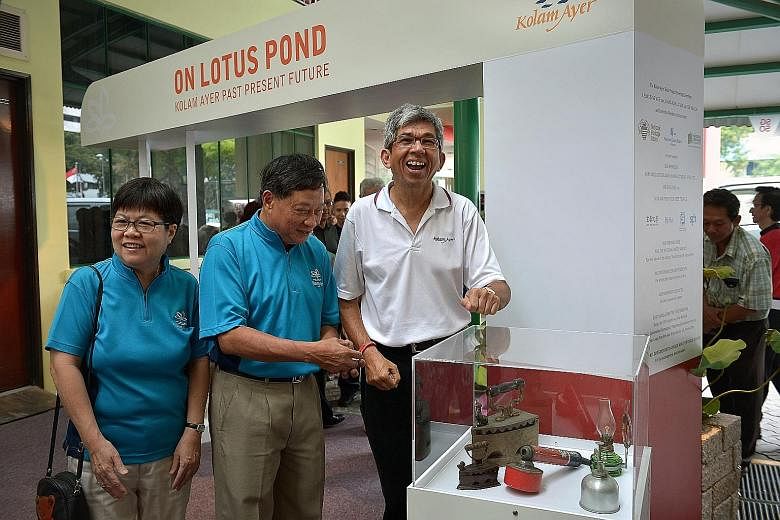 Dr Yaacob Ibrahim (right) at the exhibition at Kolam Ayer CC, along with Mrs Kiang-Koh Lai Lin, 64, who chairs the committee behind the book (below) and exhibition. With them is Mr Leong Sing Wee, 63, SG50 Kolam Ayer committee chairman.