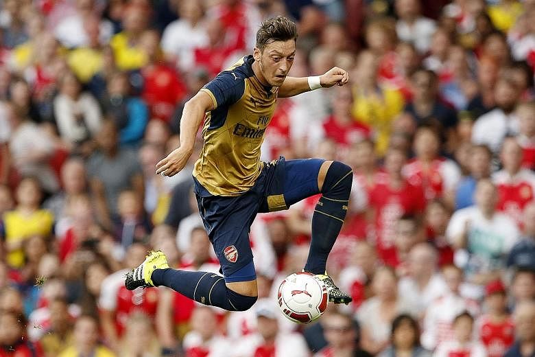Mesut Oezil (above) has started this season as Arsenal's No. 10. He scored from a free kick in their 4-1 trouncing of Liverpool in April.