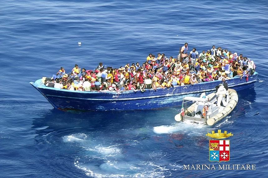 An image released by the Italian navy shows a boat crowded with refugees off the Italian coast last Saturday.