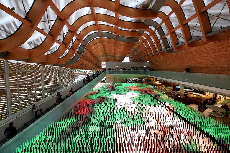 Visitors passing by a giant light installation inside the China pavilion at Expo 2015 in Milan, Italy, on Sunday. Milan won the bid in 2008 to host the international event that officials estimated at the time could generate €3.7 billion (S$5.9 bill