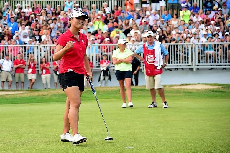 Lydia Ko of New Zealand celebrates her putt to beat Stacy Lewis (background, in yellow) on the first play-off hole at the Canadian Women's Open in Vancouver on Sunday. It was the third victory at the tournament in four years for the 18-year-old.