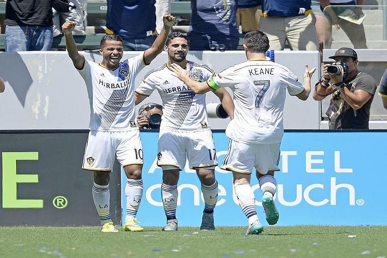 Giovani dos Santos (No. 10) of Los Angeles Galaxy celebrates his goal with team-mates Robbie Keane (No.7) and Sebastian Lletget (No. 17) against New York City FC.