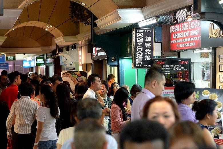 The Malaysian ringgit's free fall against the Singapore dollar stood out amid yesterday's global rout of currencies, stocks and commodities. For the first time, one Singapore dollar could fetch RM3 in foreign exchange trading. Long queues formed at m