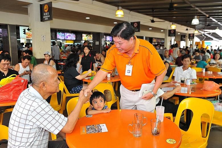 Mr Sebastian Teo greeting a resident at a walkabout in Tampines on July 26.