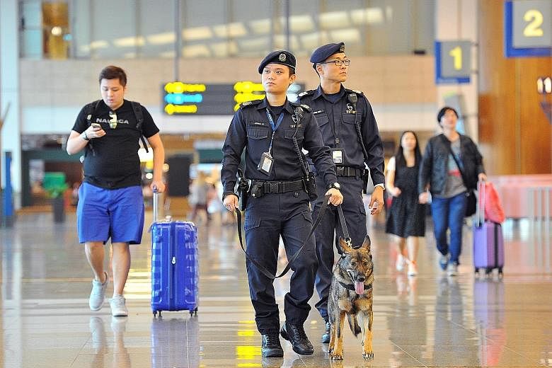 The police dog unit (above) patrolling the airport, and early-morning commuters at the Ang Mo Kio MRT station. Security and transport issues will likely figure during the campaigning for GE15.