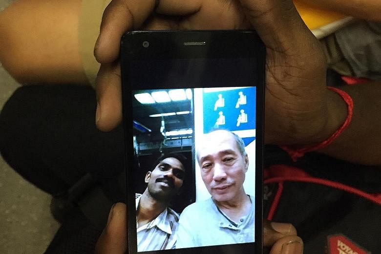 Top: Mr Saravanan breaking into a smile after Mr Lau told him and two other foreign construction workers that they did not have to give up their train seats to men. Above: The selfie taken by Mr Saravanan.