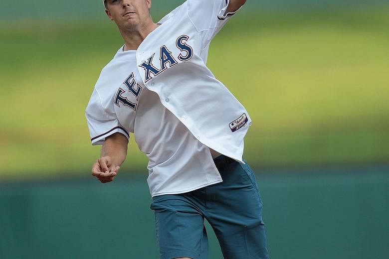 Jordan Spieth throwing the ceremonial first pitch of the Major League Baseball game between the Seattle Mariners and the Texas Rangers last week. The golfer is trying to peak for the Tour Championship, the last event of the FedExCup play-offs.