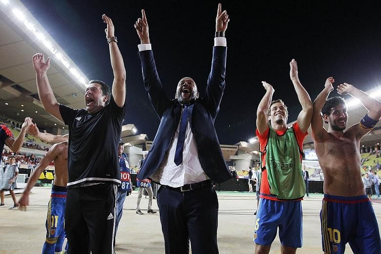 Coach Nuno Espirito Santo (centre) and captain Dani Parejo (right) acknowledging the cheers of supporters after Velencia edged out Monaco and qualified for the Champions League's knockout stage on Tuesday. The Spanish club are back among Europe's eli