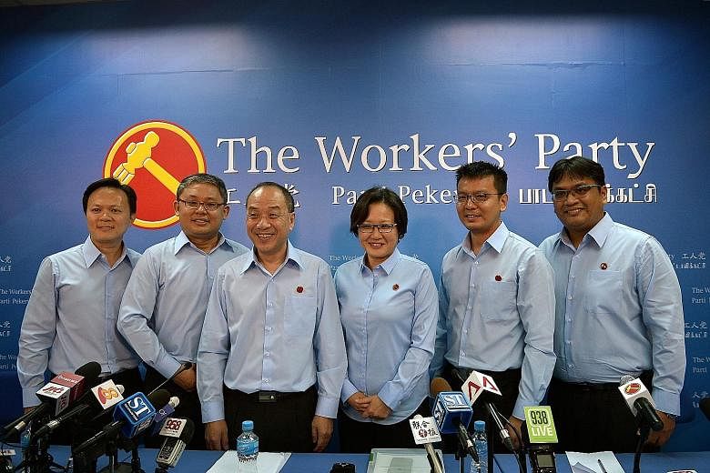 Workers' Party chief Low Thia Khiang and chairman Sylvia Lim (both in the middle) in a group picture with the party's candidates (from left) Dylan Ng, Koh Choong Yong, Daniel Goh and Redzwan Hafidz in the coming polls. Mr Koh contested the Sengkang W