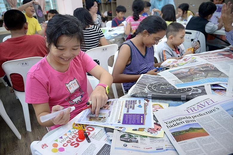 Children at Ang Mo Kio Family Service Centre - Basic enjoying their financial literacy lesson which comes in the form of scrapbooking activities based on material from The Straits Times.
