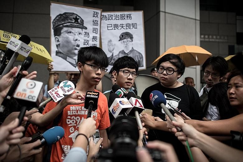 Hong Kong student leader Joshua Wong (far left) is accusing the authorities of a witch-hunt against those at the forefront of the "Umbrella Movement". He is facing several charges for his role in the protests.