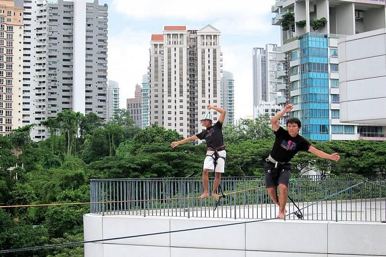 Oyster bar Southbridge (above) on a rooftop in Boat Quay offers a panoramic view of the Singapore River, while the Elephant Slacklines group (left) practises slacklining on the roof of *Scape mall.