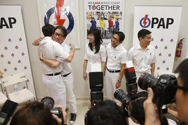 Mr Raymond Lim (left) and Manpower Minister Lim Swee Say hugging each other yesterday.