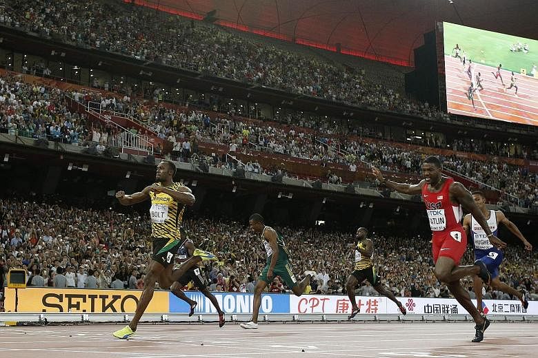 A TV cameraman on a Segway mows down Usain Bolt, who was celebrating his victory in the men's 200m. Fortunately, he was not injured. The Jamaican (far left) had beaten arch-rival Justin Gatlin (in red) with ease.
