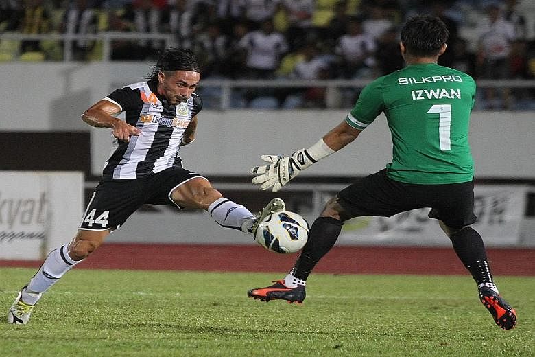 Terengganu's Issey Farran Nakajima scoring against LionsXIl's Izwan Mahbud. The Malaysian side were knocked out of the FA Cup by Fandi Ahmad's men this season and will be out for revenge.