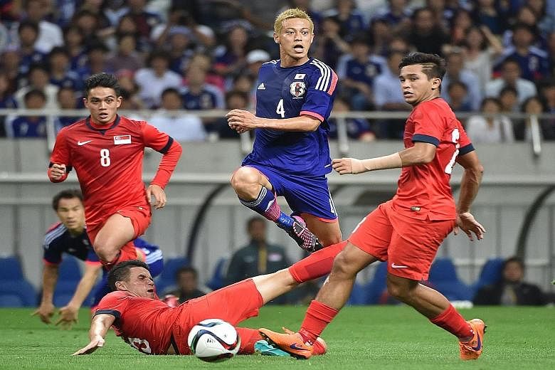 Japan midfielder Keisuke Honda (centre, in blue) launches one of several unsuccessful attacks against Singapore during the dramatic 0-0 draw in the World Cup qualifier in Saitama, Japan on June 16. Head coach Bernd Stange will rely heavily on a simil