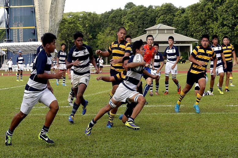 James Leow of St Andrew's sprints clear to score the winning try against ACS(I) in the Schools National C Division rugby final yesterday.