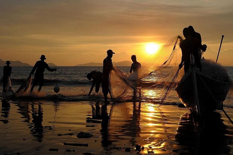Fishermen in Banda Aceh (left) cleaning their nets. The planned airstrips will connect fishermen to markets at home and abroad, said Maritime Affairs and Fisheries Minister Susi Pudjiastuti (above).