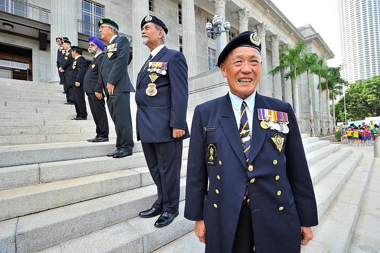 (From front) SWO (Ret) William Wee, 1WO (Ret) Salleh Suratee, Capt (Ret) Hong Seng Mak, members of the SAF Veterans League, on the steps of the National Gallery Singapore yesterday.