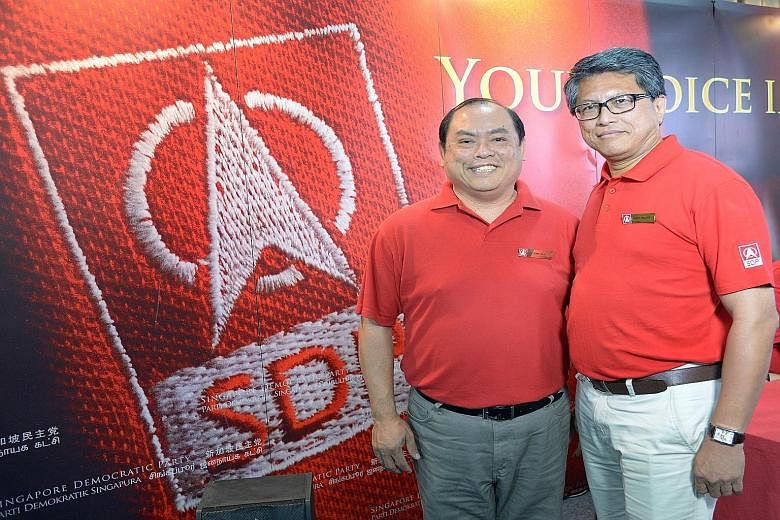 Mr John Tan Liang Joo (left), who feels troubled when he sees poor families struggle to climb up the social ladder, says he wants to raise the issue of a minimum wage. He was introduced as the SDP's candidate yesterday, along with Mr Sidek Mallek, wh