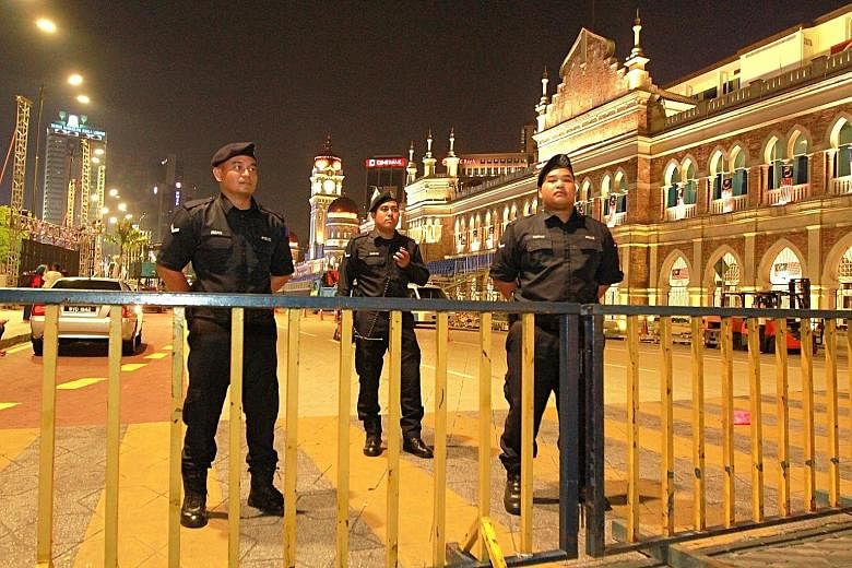 Security personnel at an entrance to Merdeka Square in Kuala Lumpur. The police have barred Bersih participants from entering the square as the organisers did not obtain approval to hold the rally there.
