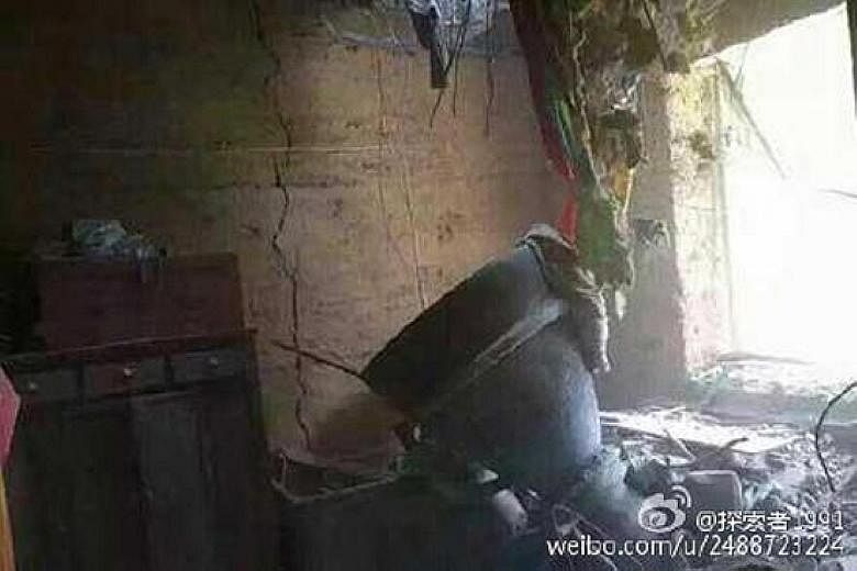 A picture from Sina Weibo showed what appeared to be a piece of a rocket in front of a cracked wall and with pieces of broken bricks on the ground.