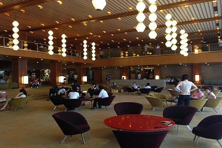 Fans lament the loss of Hotel Okura's public spaces, including the wide-open lobby (left) with its pendant lights, paper screens (above) and a map of the world with lit-up timezones (right). Since its opening in 1962, Hotel Okura has welcomed interna