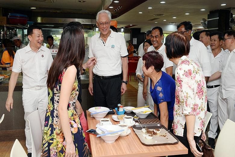 Emeritus Senior Minister Goh Chok Tong on a walkabout in Aljunied GRC with PAP candidates Victor Lye (far left) and Shamsul Kamar (to Mr Goh's left), who will both be running in the constituency. There are 24 new faces in the PAP's slate for this yea