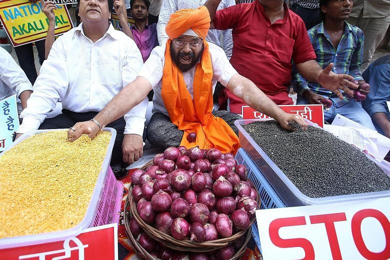 An activist with the National Akali Dal party protesting with other activists against the spike in prices of essential foods such as onions and pulses in New Delhi, India. Indian consumers are facing a crisis as the price of onion in many cities has 