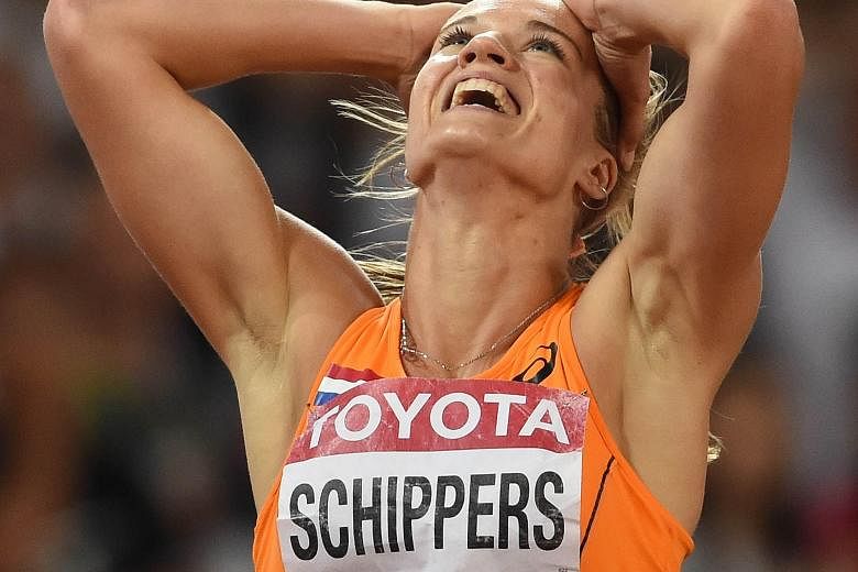 Dafne Schippers of the Netherlands celebrating her exhilarating victory in the 200m in Beijing yesterday. Schippers, who earlier won silver in the 100m, lunged to win in 21.63 seconds, edging out Jamaica's Elaine Thompson by just three-hundredths of 