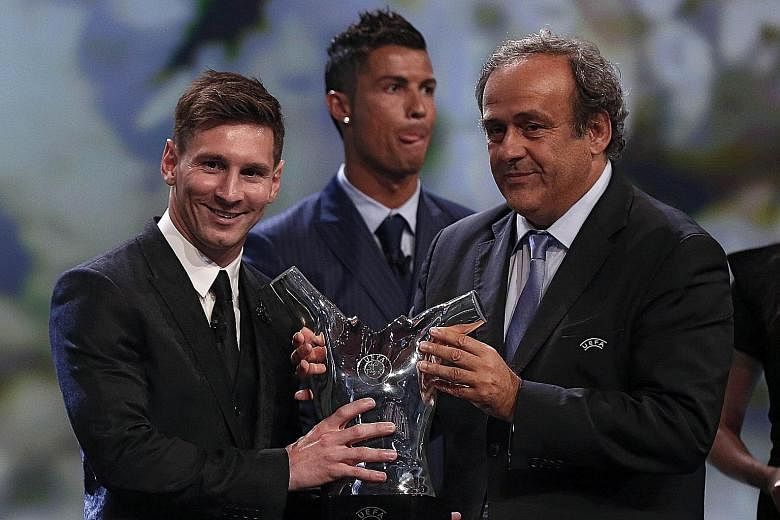 Lionel Messi (far left) receiving the trophy for the best men's player in Europe last season from Uefa president Michel Platini, with rival Cristiano Ronaldo (centre) of Real Madrid coming in second. The Argentinian becomes the first two-time winner 