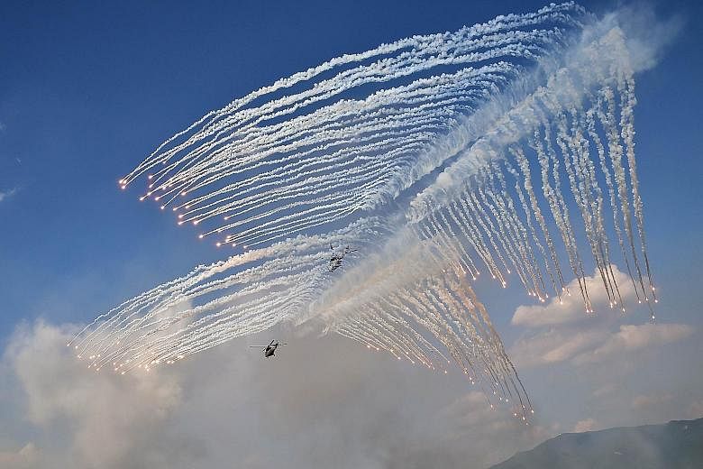 South Korean Army Surion helicopters firing flares during a joint drill yesterday between South Korea and the US at the Seungjin Fire Training Field in Pocheon, about 20km south of the demilitarised zone.