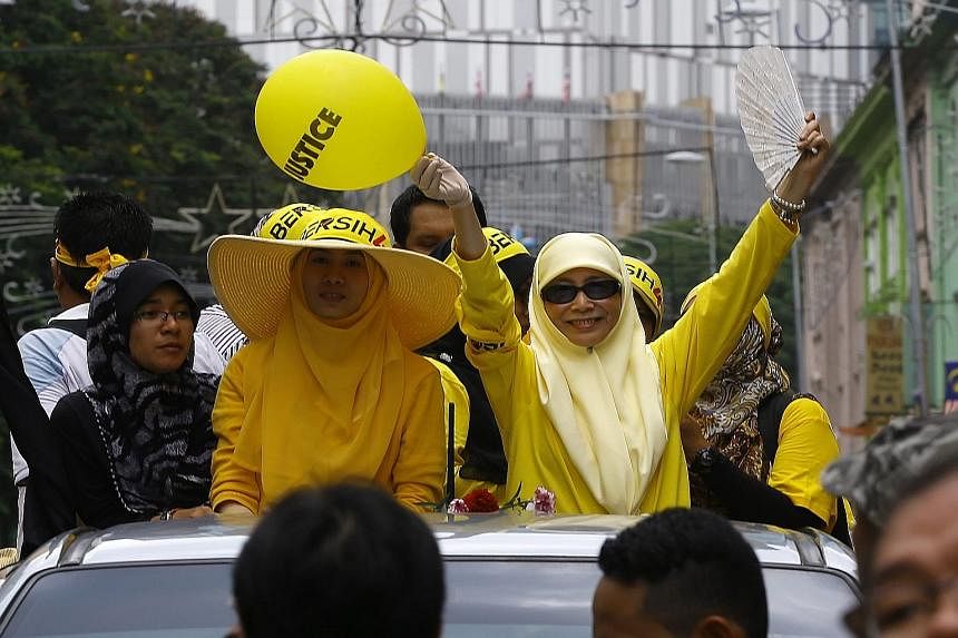 Clockwise from right: Malaysia's ex-PM Mahathir Mohamad and his wife Siti Hasmah dropped in on the Bersih event yesterday; the group's chairman Maria Chin Abdullah rallying the supporters; Wan Azizah (in sunglasses), the wife of jailed opposition lea